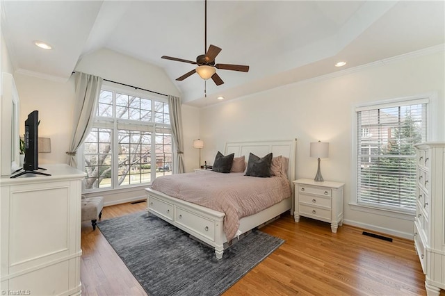 bedroom featuring lofted ceiling, recessed lighting, visible vents, and light wood-style floors