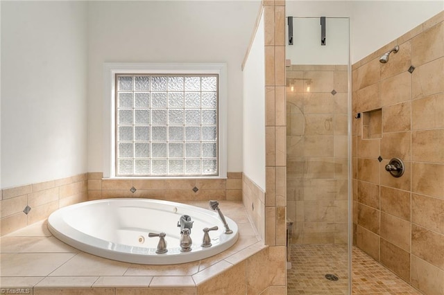 bathroom featuring a garden tub and a tile shower