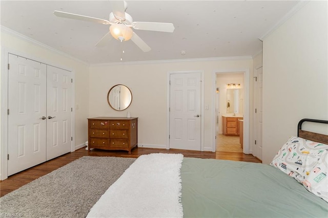 bedroom featuring crown molding, a closet, ceiling fan, wood finished floors, and baseboards