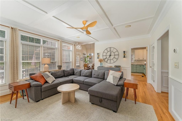 living room with ceiling fan, light wood-style flooring, coffered ceiling, and a wealth of natural light