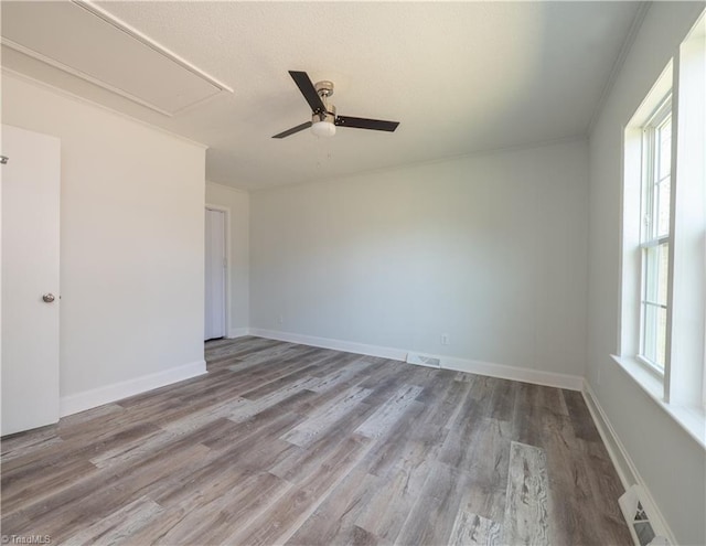 1473 Briarcliff Dr, Asheboro, NC 27205 - empty room featuring wood finished floors, a ceiling fan, visible vents, baseboards, and attic access