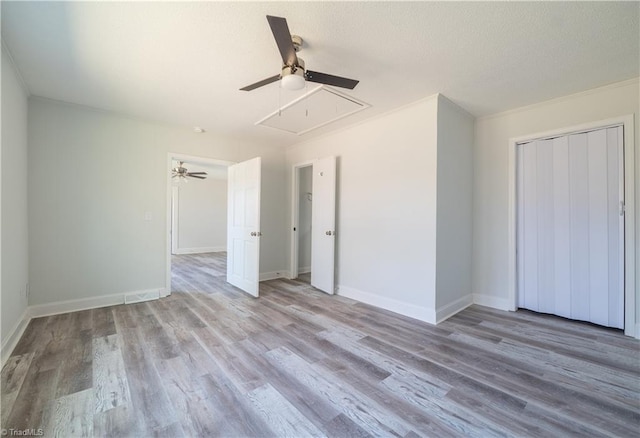 1473 Briarcliff Dr, Asheboro, NC 27205 - unfurnished bedroom with a ceiling fan, a textured ceiling, wood finished floors, a closet, and attic access