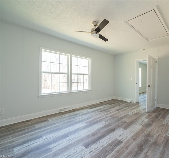 1473 Briarcliff Dr, Asheboro, NC 27205 - empty room with wood finished floors, visible vents, attic access, ceiling fan, and a textured ceiling