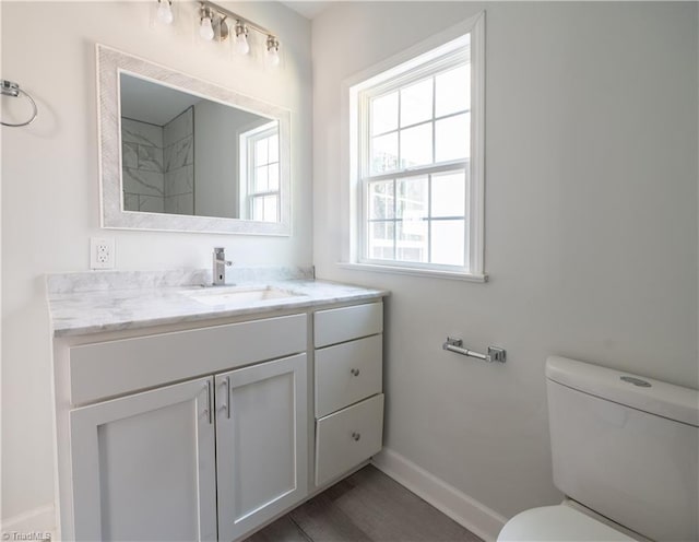 1473 Briarcliff Dr, Asheboro, NC 27205 - bathroom featuring baseboards, toilet, wood finished floors, and vanity