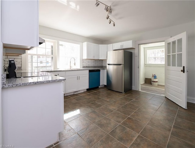 1473 Briarcliff Dr, Asheboro, NC 27205 - kitchen with dishwasher, decorative backsplash, freestanding refrigerator, white cabinets, and a sink