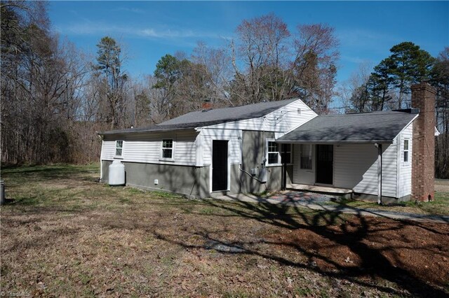 1473 Briarcliff Dr, Asheboro, NC 27205 - back of property with a carport, a yard, and a chimney