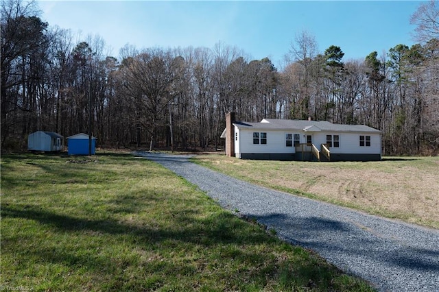 1473 Briarcliff Dr, Asheboro, NC 27205 - exterior space with a forest view, a shed, a front yard, an outdoor structure, and driveway