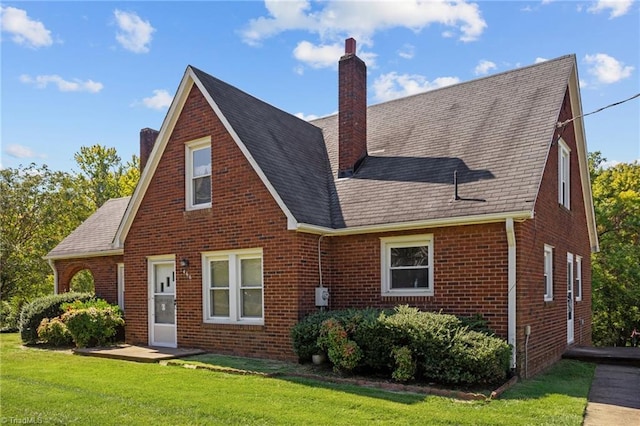 466 Main St, King, NC 27021 - back of property featuring a yard, a shingled roof, a chimney, and brick siding