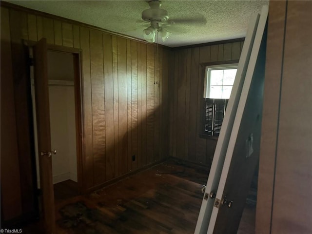615 Paris St, Graham, NC 27253 - unfurnished bedroom featuring wooden walls, dark wood-style floors, and a textured ceiling
