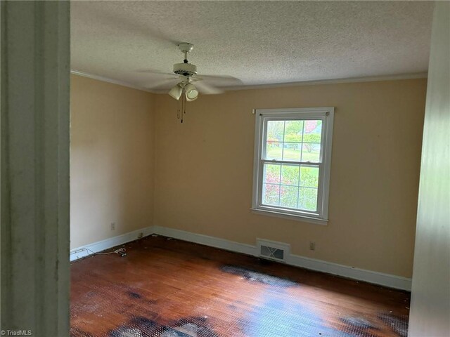 615 Paris St, Graham, NC 27253 - empty room featuring ceiling fan, a textured ceiling, ornamental molding, visible vents, and wood finished floors
