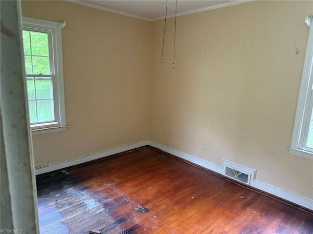 615 Paris St, Graham, NC 27253 - spare room with ornamental molding, baseboards, dark wood-style floors, and visible vents