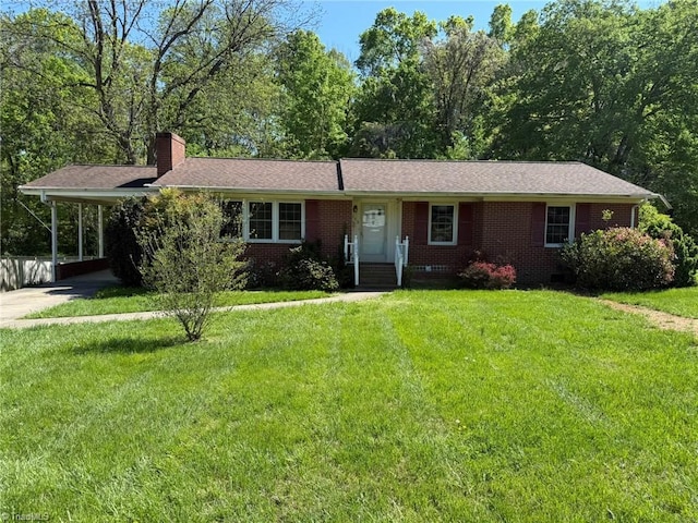 615 Paris St, Graham, NC 27253 - single story home with a front lawn, brick siding, a chimney, concrete driveway, and an attached carport