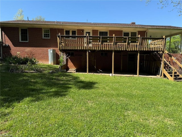 615 Paris St, Graham, NC 27253 - back of property featuring stairs, brick siding, a deck, and a yard