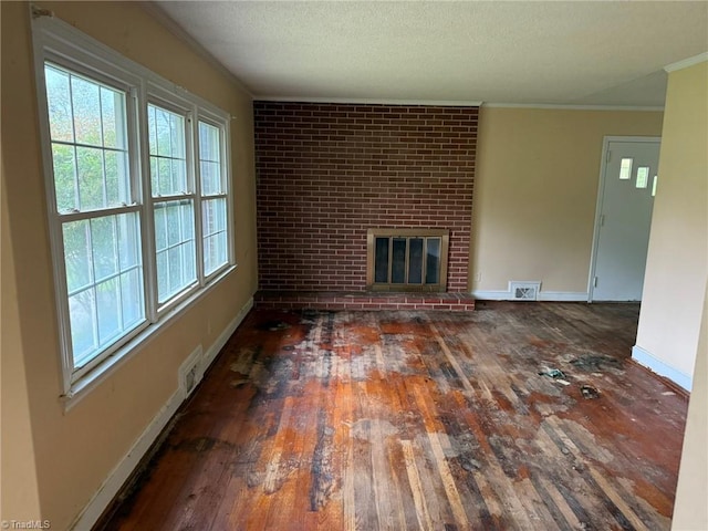 615 Paris St, Graham, NC 27253 - unfurnished living room with a fireplace, wood-type flooring, ornamental molding, and visible vents