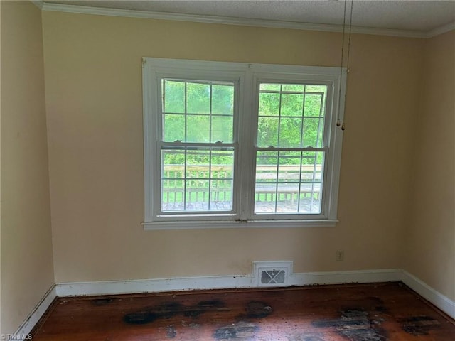 615 Paris St, Graham, NC 27253 - spare room with visible vents, baseboards, ornamental molding, and wood finished floors