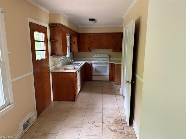 615 Paris St, Graham, NC 27253 - kitchen with light countertops, visible vents, brown cabinetry, electric stove, and a sink