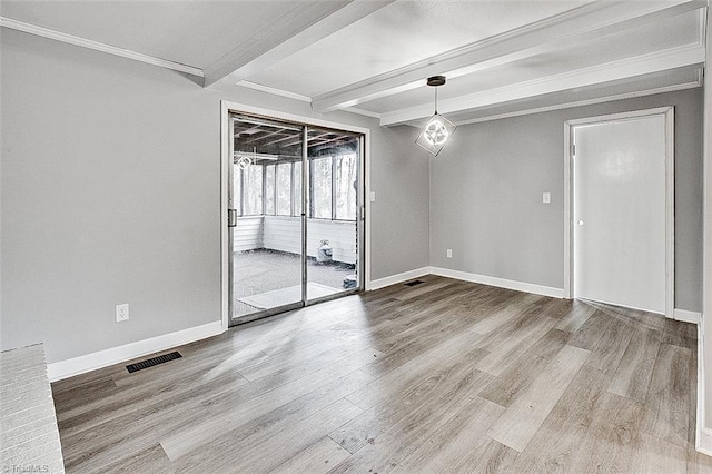 spare room with beam ceiling, crown molding, and wood-type flooring