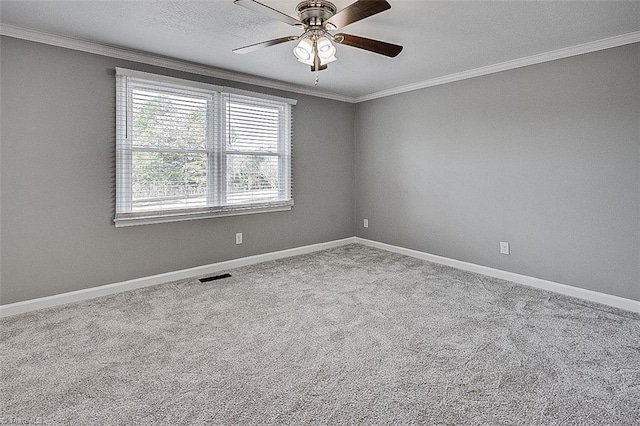 carpeted spare room with a textured ceiling, ceiling fan, and crown molding