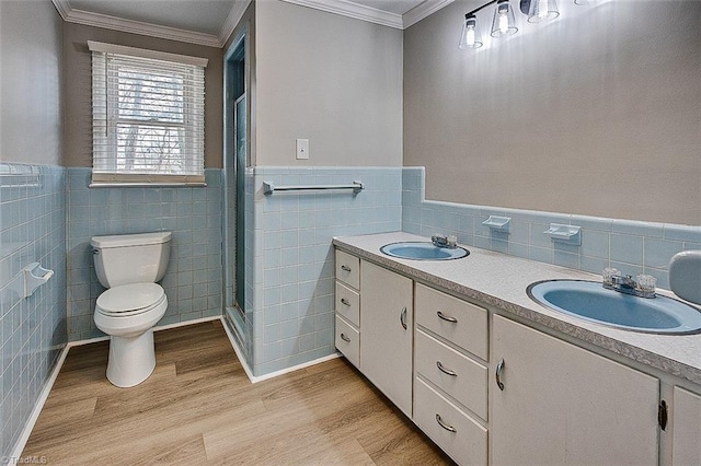 bathroom with tile walls, toilet, hardwood / wood-style floors, and vanity