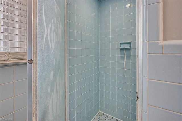 bathroom with tiled shower