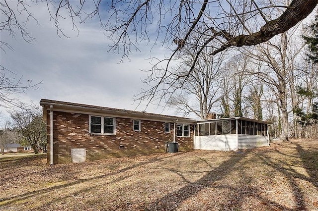 back of house featuring cooling unit and a sunroom