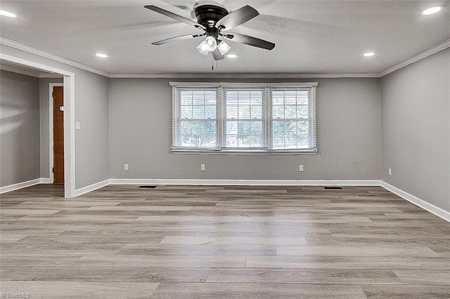 empty room featuring ceiling fan, crown molding, and light hardwood / wood-style flooring