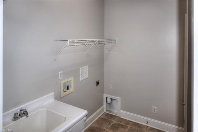 clothes washing area with dark tile patterned floors, washer hookup, laundry area, hookup for an electric dryer, and a sink