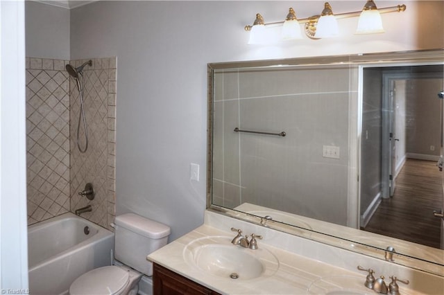 bathroom with a sink, bathing tub / shower combination, toilet, and double vanity