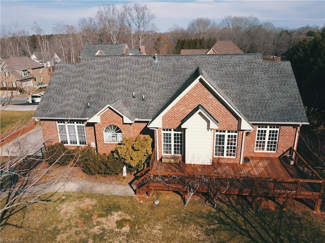 view of front of property with brick siding and a shingled roof