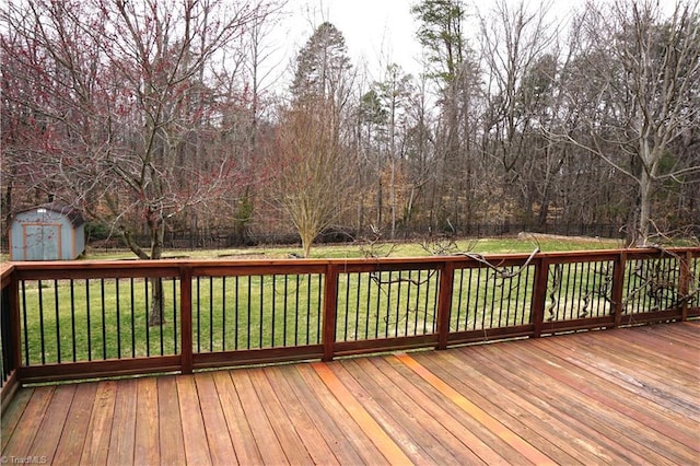 wooden deck featuring a yard, a shed, an outdoor structure, and fence