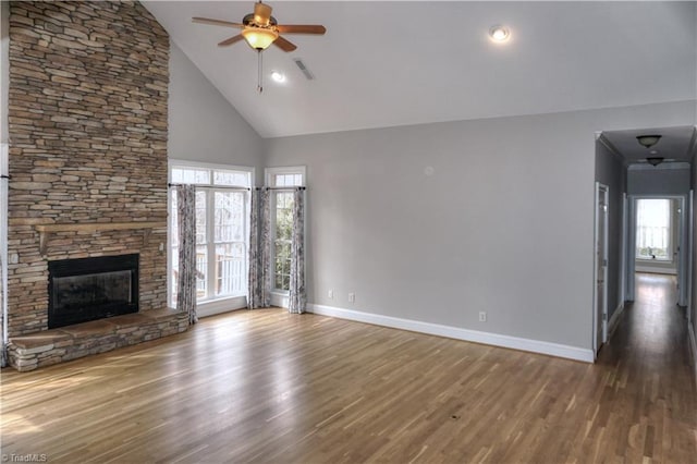 unfurnished living room with visible vents, baseboards, wood finished floors, and a ceiling fan