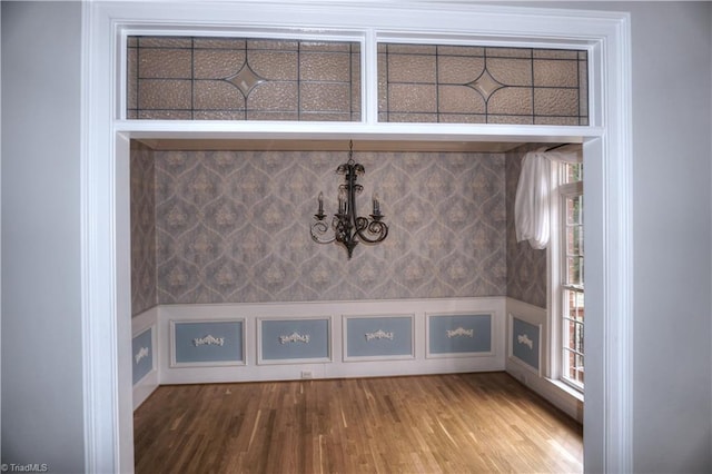 interior details featuring an inviting chandelier and wood finished floors