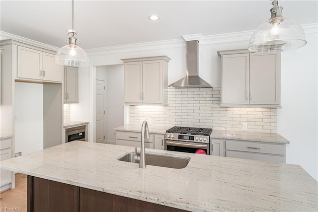 kitchen featuring ornamental molding, a sink, tasteful backsplash, wall chimney range hood, and stainless steel range with gas stovetop
