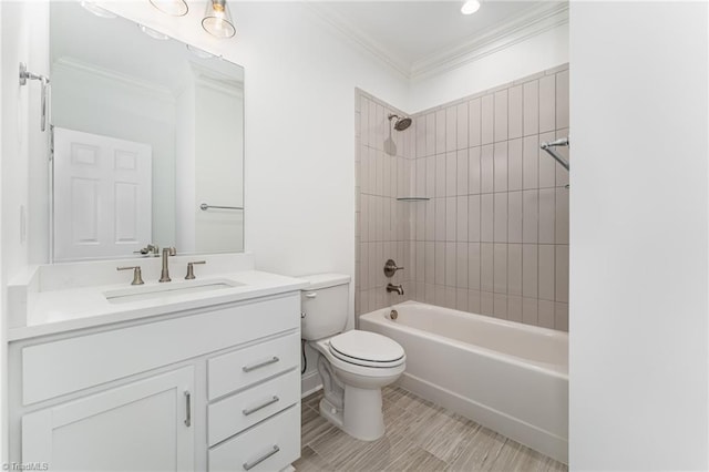 full bathroom with ornamental molding, vanity, toilet, and tiled shower / bath combo