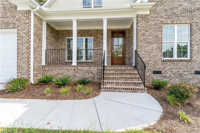 property entrance featuring crawl space, board and batten siding, a garage, and a porch