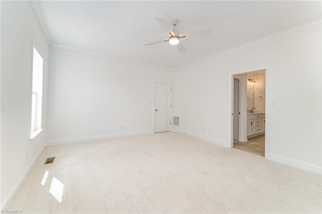 unfurnished bedroom with visible vents, light colored carpet, crown molding, and baseboards