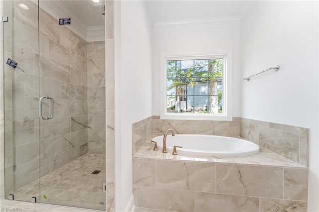 bathroom with a bath, a stall shower, and ornamental molding