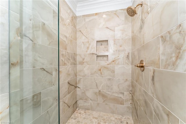 full bath with crown molding and tiled shower