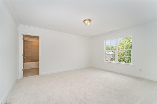 unfurnished room with ornamental molding, baseboards, and light carpet