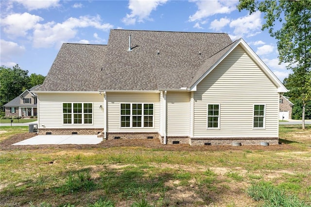 rear view of property with a shingled roof, a patio area, and crawl space