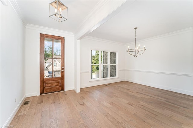 foyer with light wood finished floors, visible vents, a wealth of natural light, and an inviting chandelier