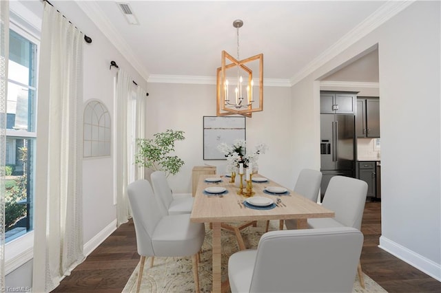 dining area with dark wood-type flooring, a notable chandelier, crown molding, and plenty of natural light