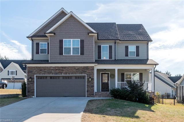 craftsman house featuring a garage, a front lawn, and covered porch