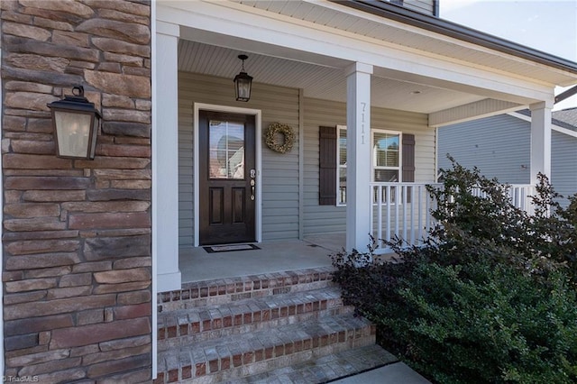 view of exterior entry featuring a porch