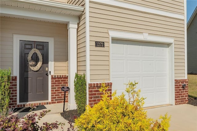 1272 Adrian Ct, Mebane, NC 27302 - entrance to property with brick siding, a garage, and driveway