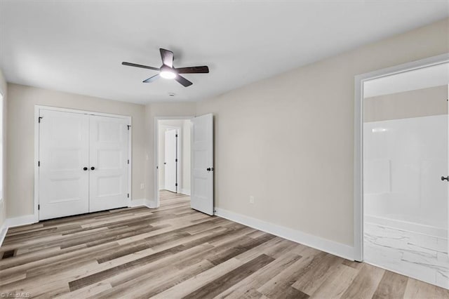3077 Little Creek Dr, Thomasville, NC 27360 - unfurnished bedroom featuring ensuite bath, a closet, wood finished floors, and ceiling fan