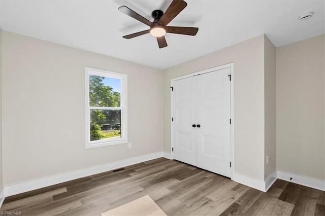 3077 Little Creek Dr, Thomasville, NC 27360 - unfurnished bedroom with wood finished floors, a closet, and ceiling fan
