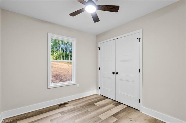 3077 Little Creek Dr, Thomasville, NC 27360 - unfurnished bedroom with light wood-style flooring, a closet, and a ceiling fan