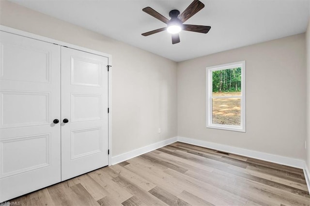 3077 Little Creek Dr, Thomasville, NC 27360 - unfurnished bedroom with light wood finished floors, a closet, and a ceiling fan