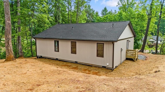 3077 Little Creek Dr, Thomasville, NC 27360 - back of property featuring a shingled roof, view of scattered trees, and crawl space